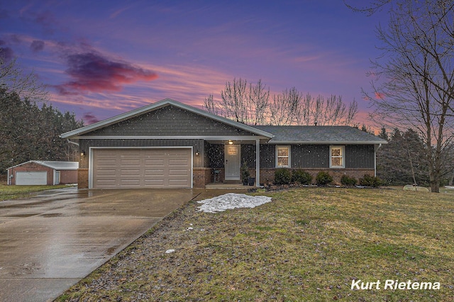 view of front facade with driveway, brick siding, an attached garage, and a lawn