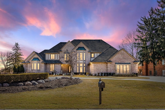 french provincial home featuring a front lawn