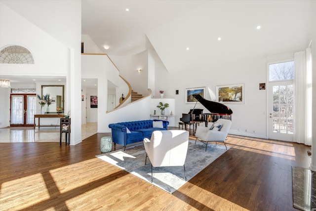 1265 Water Cliff Dr, Bloomfield Hills, MI 48302 - living area featuring high vaulted ceiling, stairs, and wood finished floors