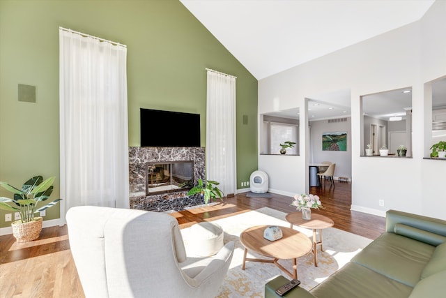 1265 Water Cliff Dr, Bloomfield Hills, MI 48302 - living area featuring high vaulted ceiling, wood finished floors, and a fireplace