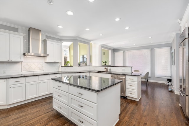 1265 Water Cliff Dr, Bloomfield Hills, MI 48302 - kitchen with wall chimney exhaust hood, stainless steel appliances, a peninsula, ornamental molding, and a kitchen island