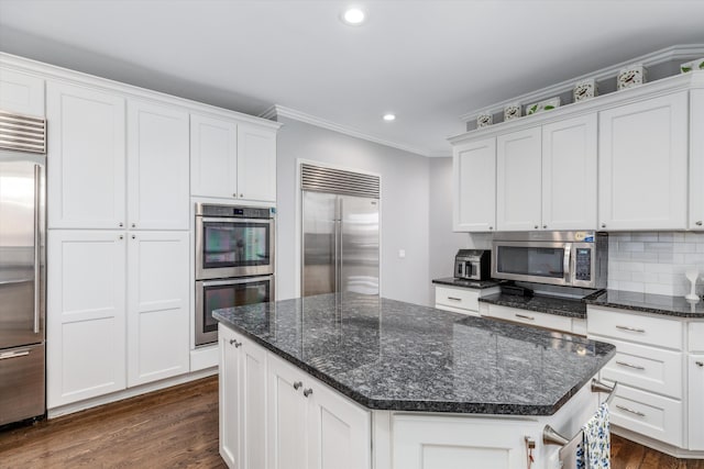 1265 Water Cliff Dr, Bloomfield Hills, MI 48302 - kitchen featuring appliances with stainless steel finishes, white cabinetry, dark wood-style flooring, crown molding, and recessed lighting