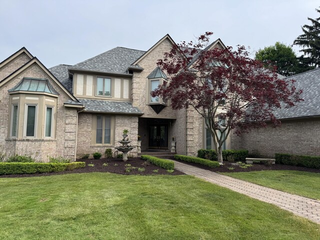 1265 Water Cliff Dr, Bloomfield Hills, MI 48302 - view of front of house with a front lawn, brick siding, and a shingled roof