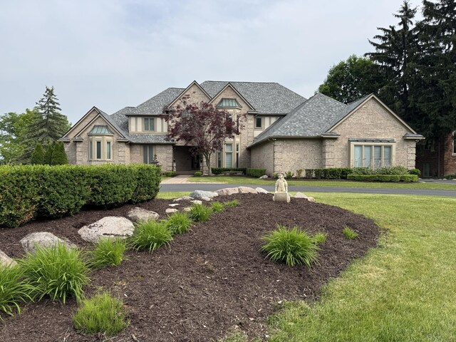 1265 Water Cliff Dr, Bloomfield Hills, MI 48302 - view of front facade featuring stone siding and a front lawn