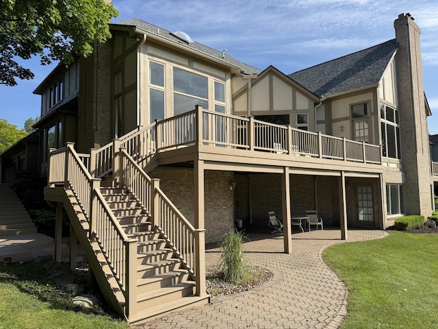 1265 Water Cliff Dr, Bloomfield Hills, MI 48302 - back of property with stucco siding, a patio area, a chimney, a yard, and a shingled roof