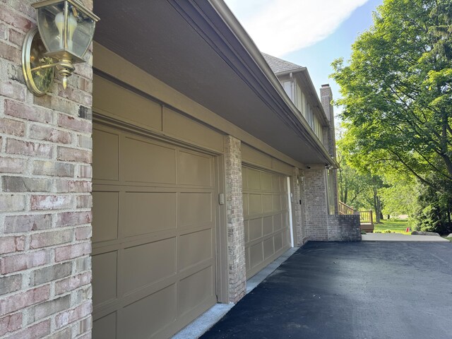 1265 Water Cliff Dr, Bloomfield Hills, MI 48302 - garage featuring asphalt driveway