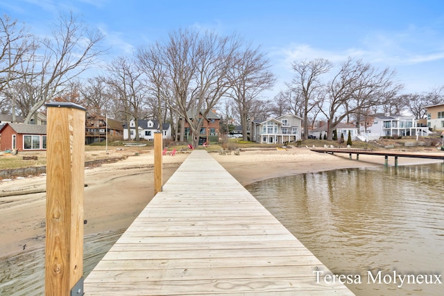 view of dock featuring a residential view and a water view