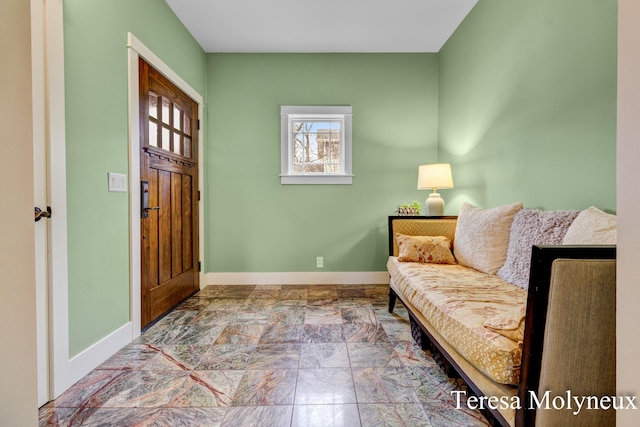 foyer entrance featuring baseboards