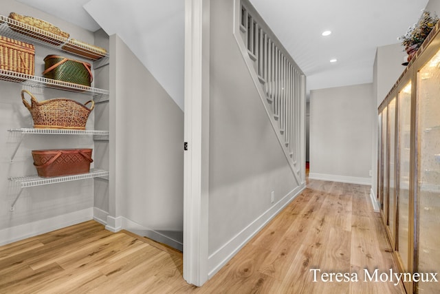 interior space featuring recessed lighting, baseboards, and wood finished floors