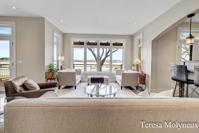 living area featuring recessed lighting and baseboards