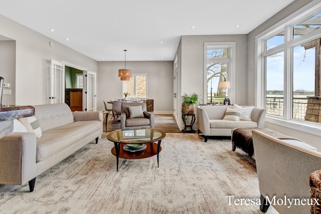 living area featuring recessed lighting, baseboards, and wood finished floors