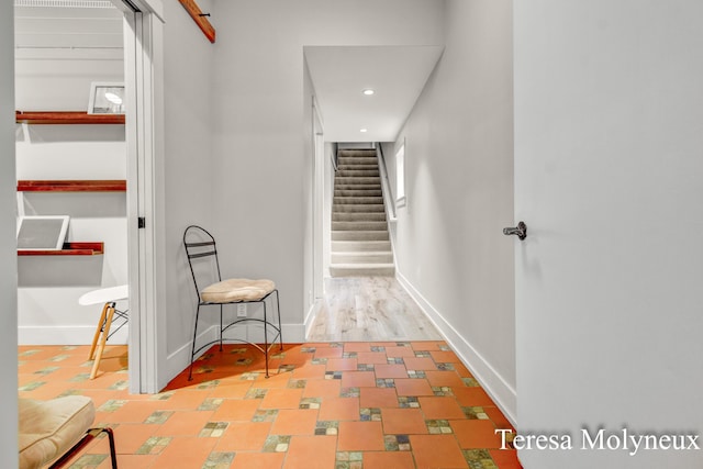 hall featuring stairway, recessed lighting, and baseboards