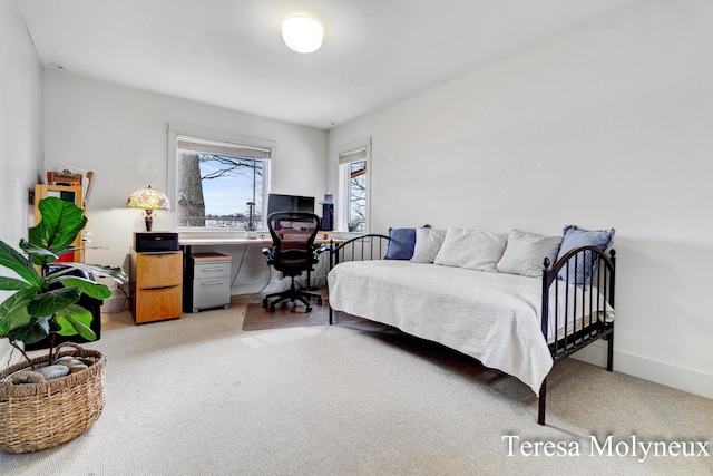 bedroom with light carpet and baseboards