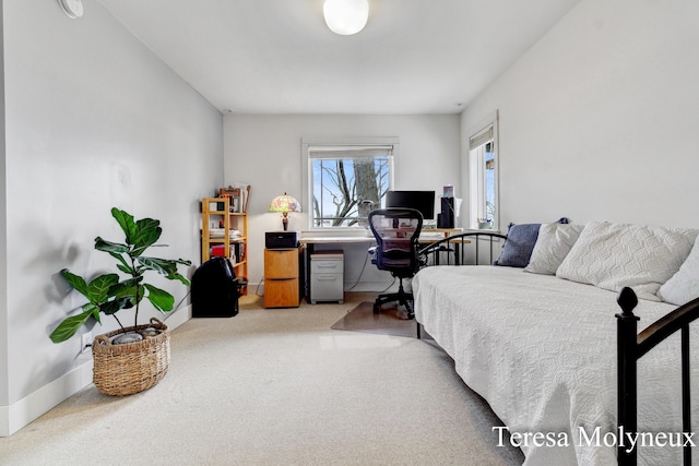 bedroom featuring light colored carpet and baseboards