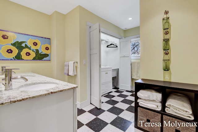 bathroom featuring tile patterned floors, baseboards, recessed lighting, and vanity