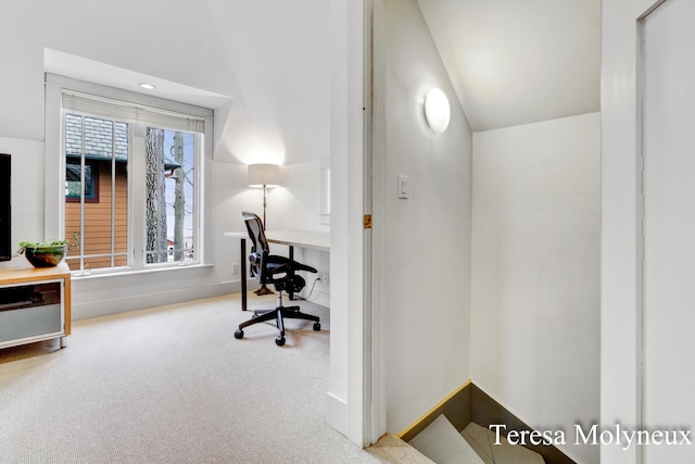 carpeted office with vaulted ceiling