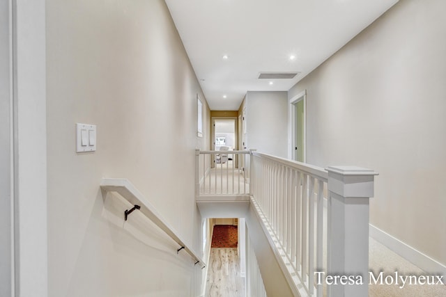 hallway with recessed lighting, an upstairs landing, visible vents, and baseboards