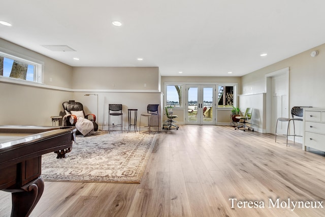 recreation room featuring wood finished floors, recessed lighting, french doors, and a wealth of natural light