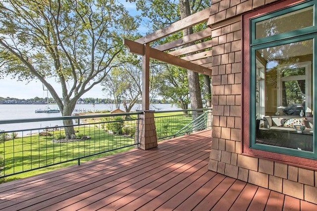 wooden deck with a pergola, a yard, and a water view