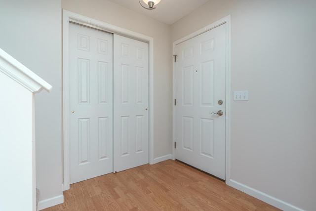 entrance foyer featuring light wood-style flooring and baseboards