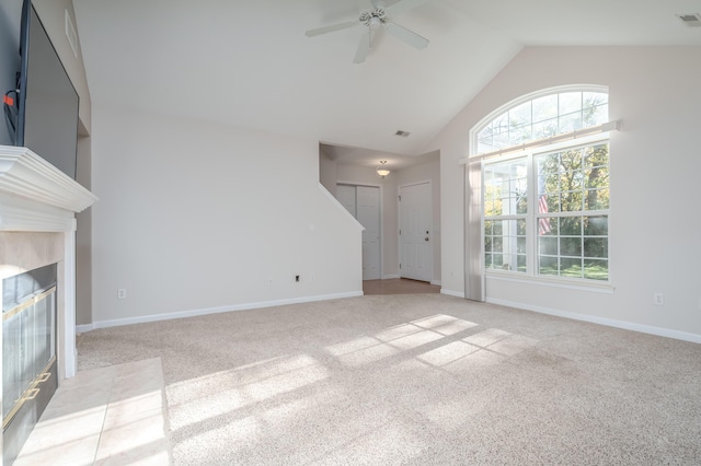 unfurnished living room with visible vents, baseboards, high vaulted ceiling, light carpet, and a tiled fireplace