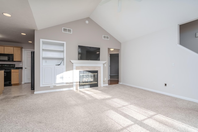 unfurnished living room with visible vents, light colored carpet, a tile fireplace, and built in features