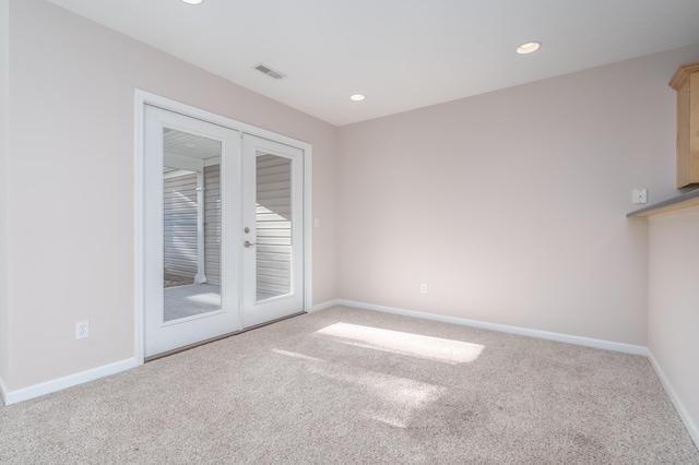 carpeted empty room featuring recessed lighting, baseboards, visible vents, and french doors