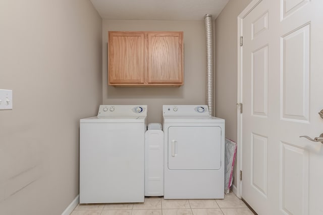 laundry room with washer and dryer, light tile patterned floors, cabinet space, and baseboards