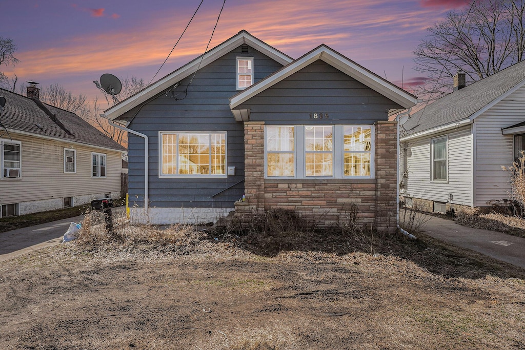 bungalow with stone siding and entry steps