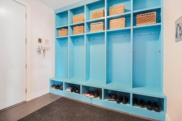 mudroom with baseboards and dark wood-style flooring
