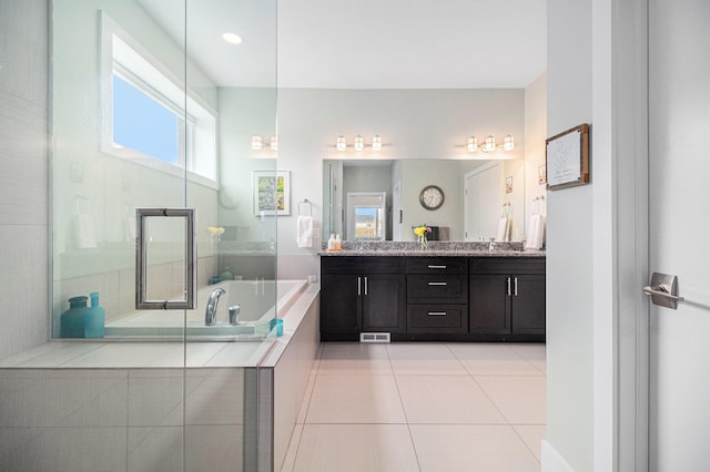 bathroom featuring a shower with shower door, vanity, tile patterned floors, visible vents, and a bath