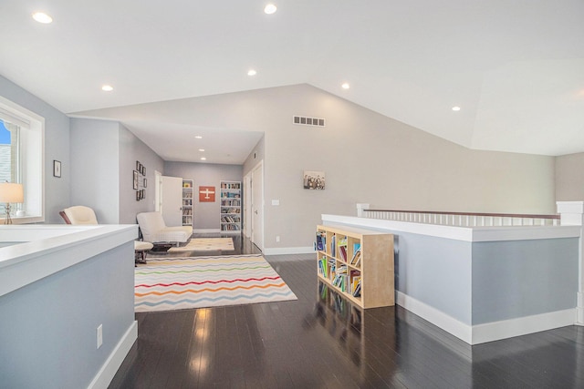interior space featuring visible vents, vaulted ceiling, wood finished floors, baseboards, and recessed lighting