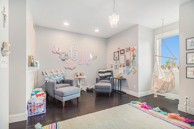 sitting room featuring baseboards, recessed lighting, hardwood / wood-style floors, and an inviting chandelier