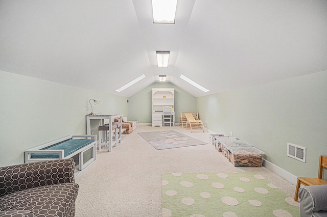 game room featuring vaulted ceiling with skylight, baseboards, carpet, and visible vents