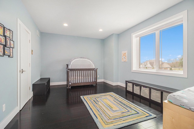 bedroom with recessed lighting, baseboards, and wood finished floors