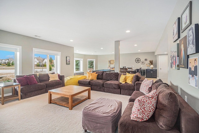 carpeted living area with recessed lighting, visible vents, and bar area