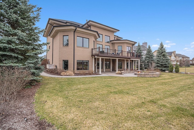 back of house with a patio, stucco siding, a yard, and a deck
