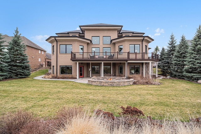 back of house with a yard, a wooden deck, and stucco siding