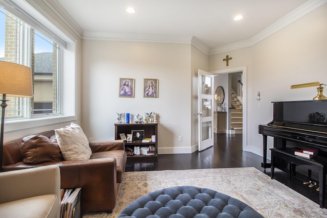living area featuring ornamental molding, a wealth of natural light, and dark wood-style floors