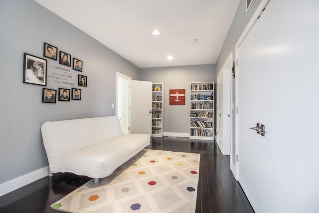 living area with baseboards, recessed lighting, and dark wood-type flooring