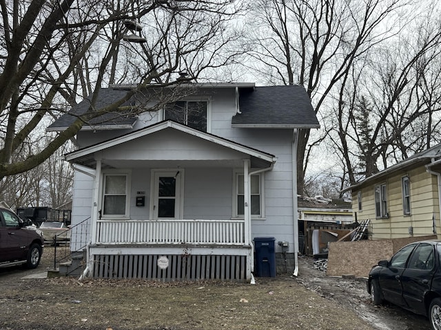 view of front of property with covered porch and roof with shingles