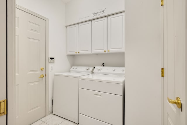 clothes washing area with light tile patterned floors, cabinet space, and separate washer and dryer