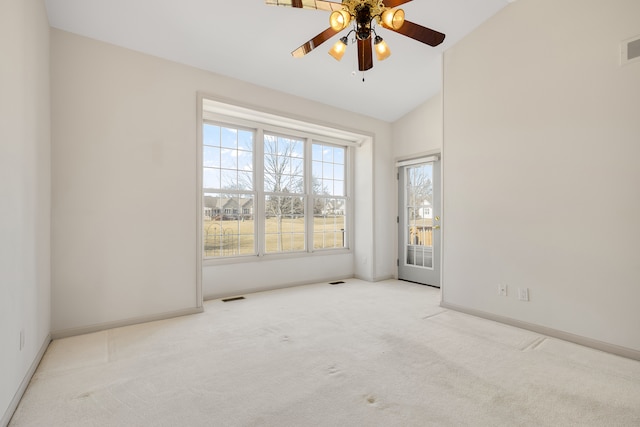 empty room with visible vents, ceiling fan, baseboards, lofted ceiling, and carpet floors