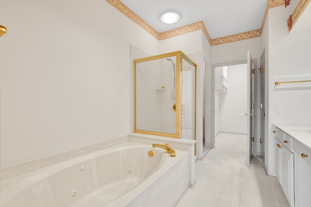 bathroom featuring vanity, a tub with jets, and a shower stall