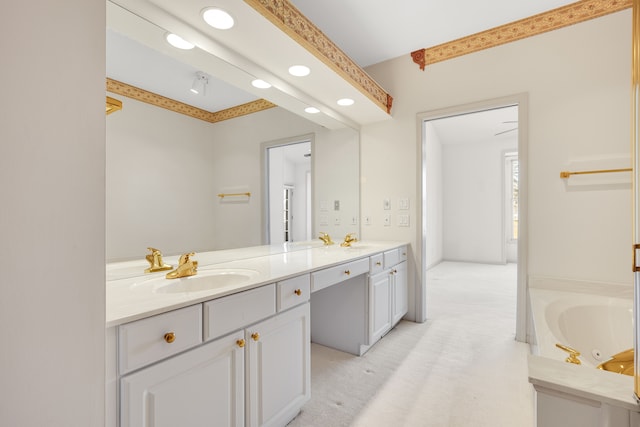 bathroom featuring a sink, a tub with jets, and double vanity