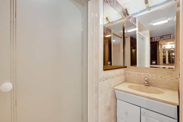 bathroom featuring tile walls and vanity