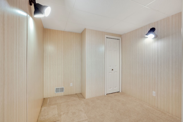 basement featuring visible vents and carpet floors