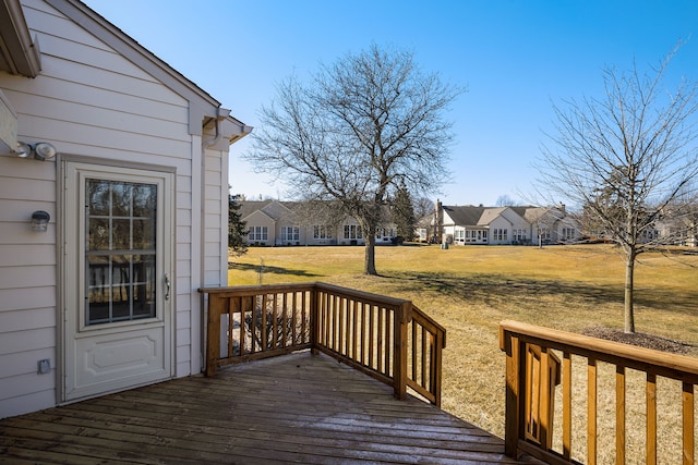 deck with a residential view and a yard