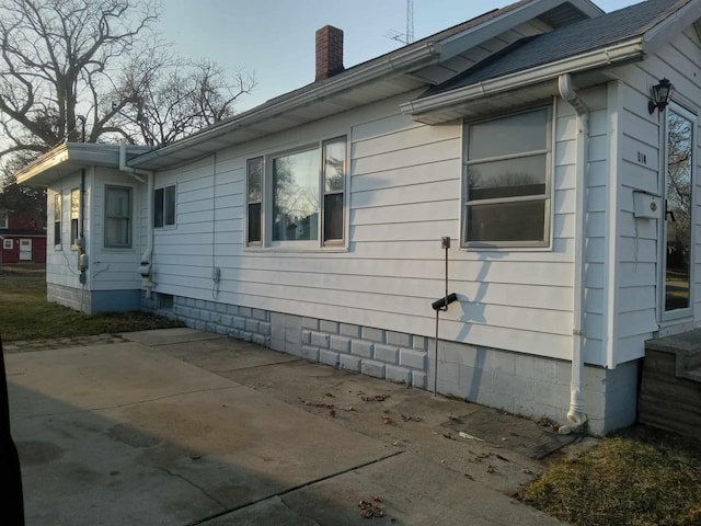 view of side of property with a chimney