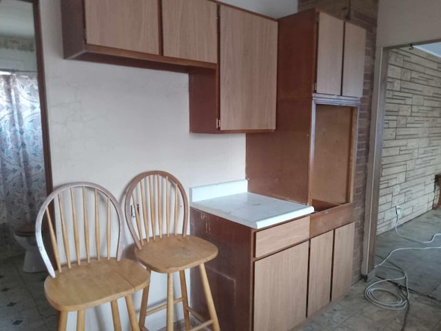 kitchen featuring light brown cabinets and light countertops